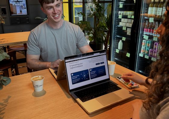 The Social Bay team testing website loading speed and performance on a laptop